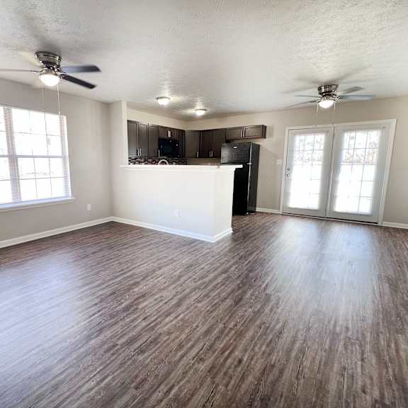 a room with wooden flooring and a ceiling fan.