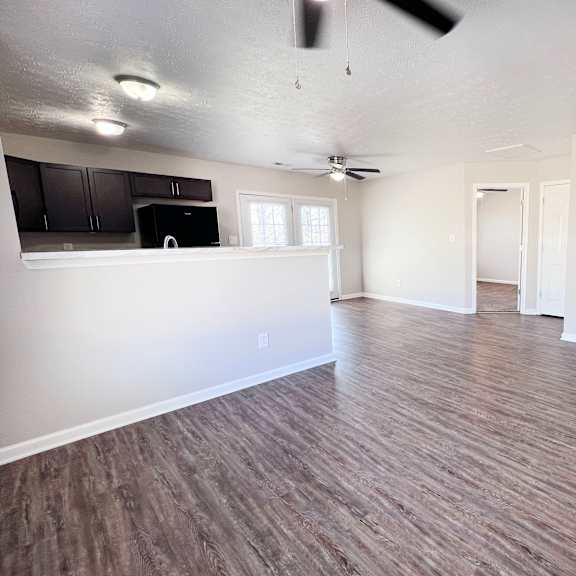 a room with wooden flooring and a ceiling fan.