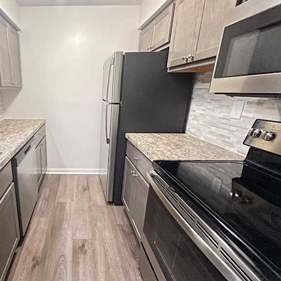 a kitchen with stainless steel appliances and marble counter tops  at deercross apartments, cincinnati, oh, 45236