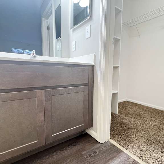 a bathroom with a vanity with a mirror and a sink  at deercross apartments, cincinnati