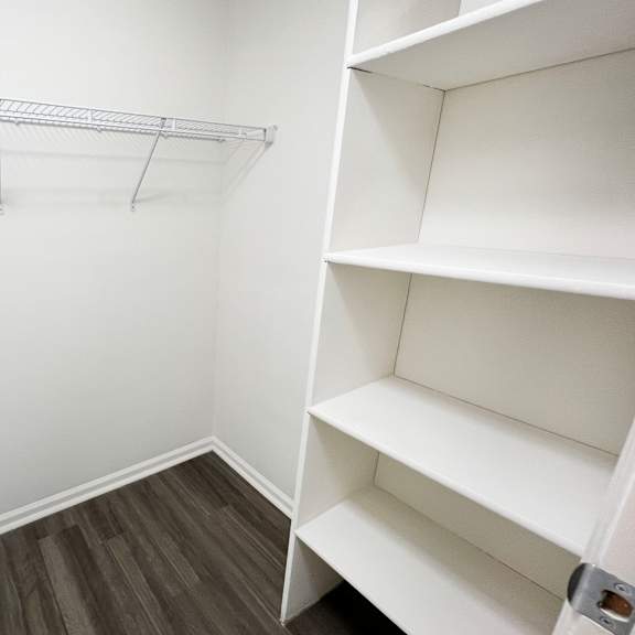 a closet in a small room with shelves and a door  at deercross apartments, cincinnati, oh, 45236