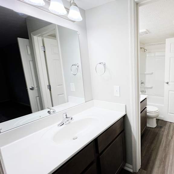 a bathroom with a sink and a mirror  at deercross apartments, ohio, 45236