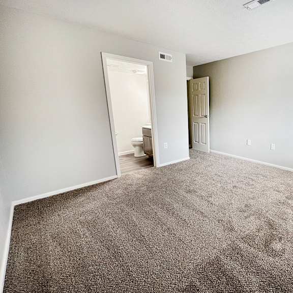 an empty living room with carpet and a closet  at deercross apartments, cincinnati, 45236