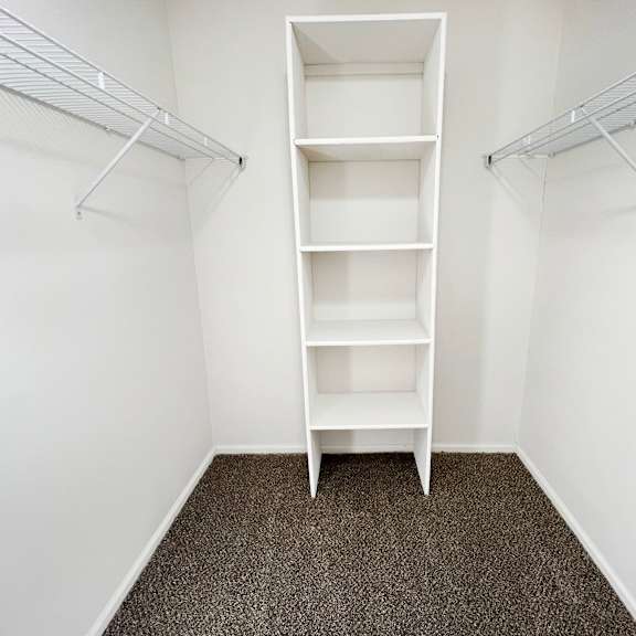 an empty closet in a room with white walls and shelves  at deercross apartments, cincinnati