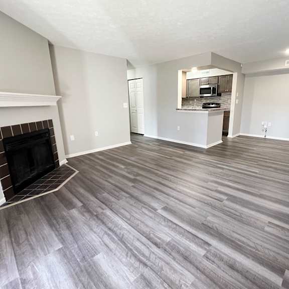 a living room with wood flooring and a fireplace  at deercross apartments, ohio, 45236