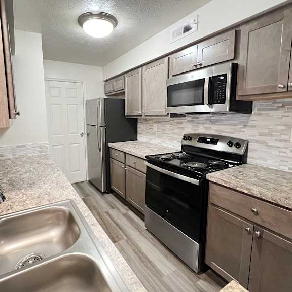 a kitchen with stainless steel appliances and granite counter tops  at deercross apartments, cincinnati, oh, 45236