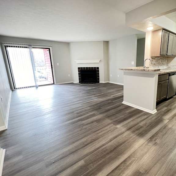 an empty living room and kitchen with wood flooring  at deercross apartments, ohio, 45236