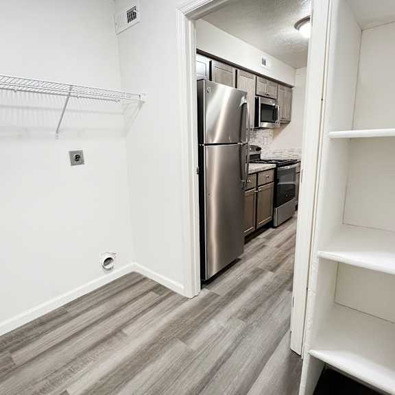an empty kitchen with a stainless steel refrigerator and  at deercross apartments, ohio