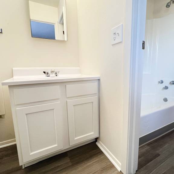 a bathroom with a sink toilet and a tub at four worlds apartments, cincinnati, ohio