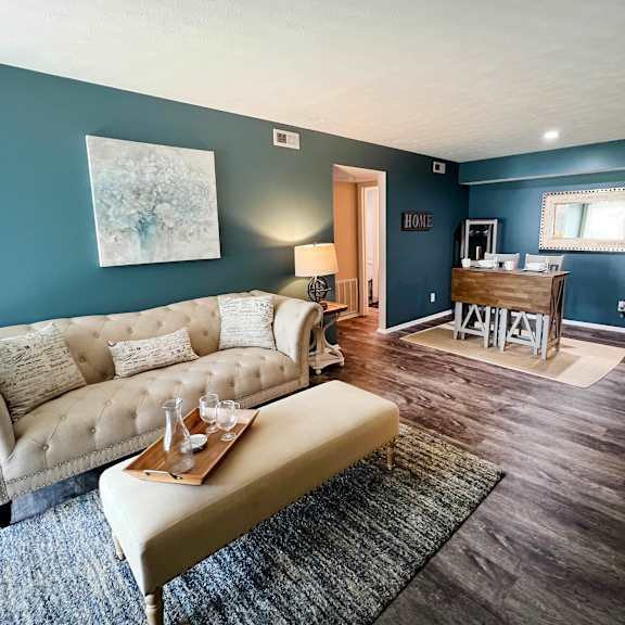 a living room with a couch and a coffee table  at steeplechase apartments, loveland