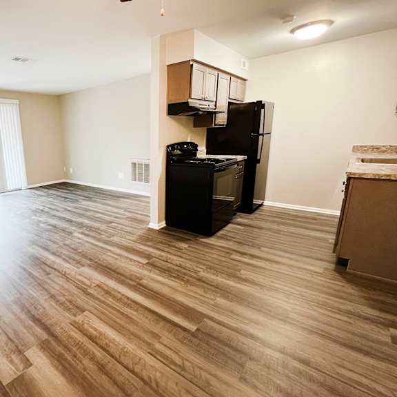 a kitchen and living room with hardwood floors at crown ridge apartments, franklin, 45005