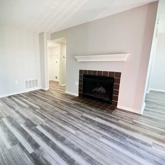 a living room with wood flooring and a fireplace  at deercross apartments, cincinnati, 45236
