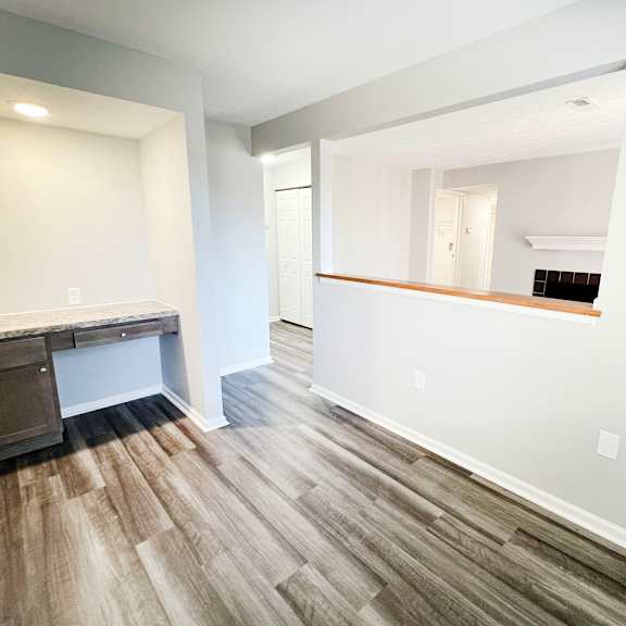 an empty room with a desk and a mirror in a new home  at deercross apartments, ohio