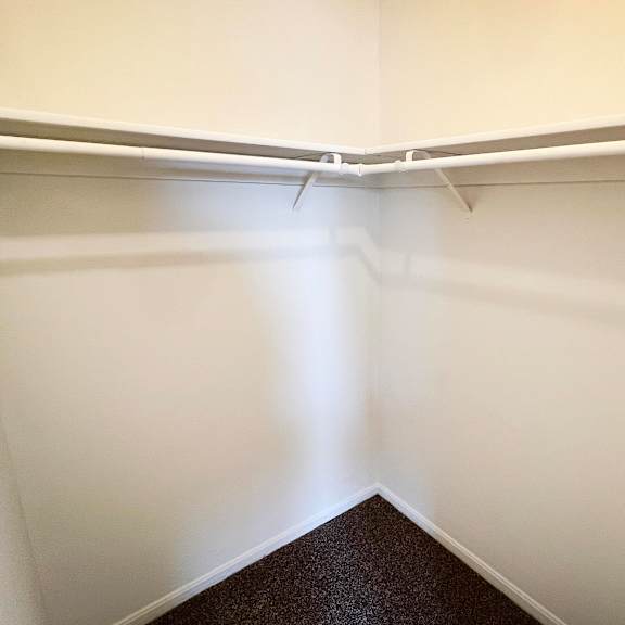 an empty closet in an empty room with white walls at crown crossing apartments, amelia, oh, 45102