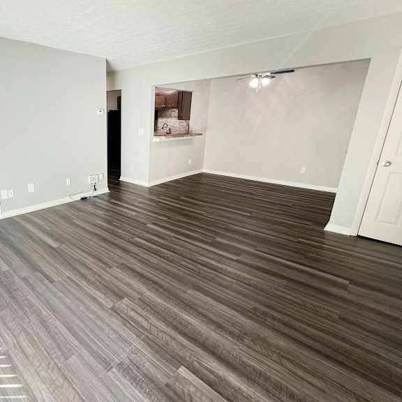 the living room of an empty apartment with wood flooring at fox run apartments, cincinnati, 45236