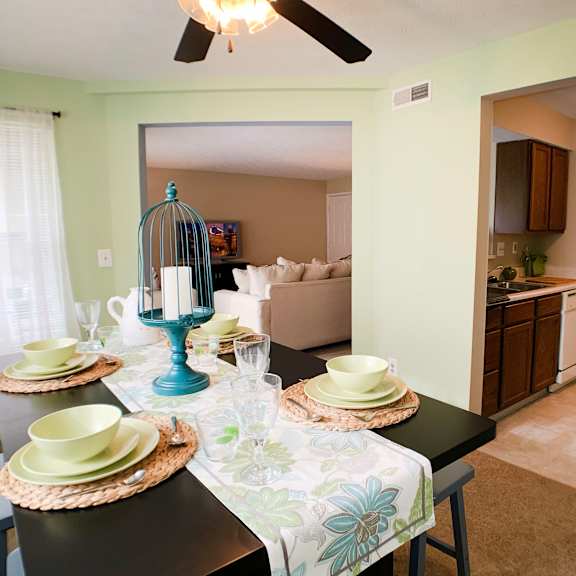 a dining room and living room with a table and chairs at the vinings apartments, cincinnati, 45245