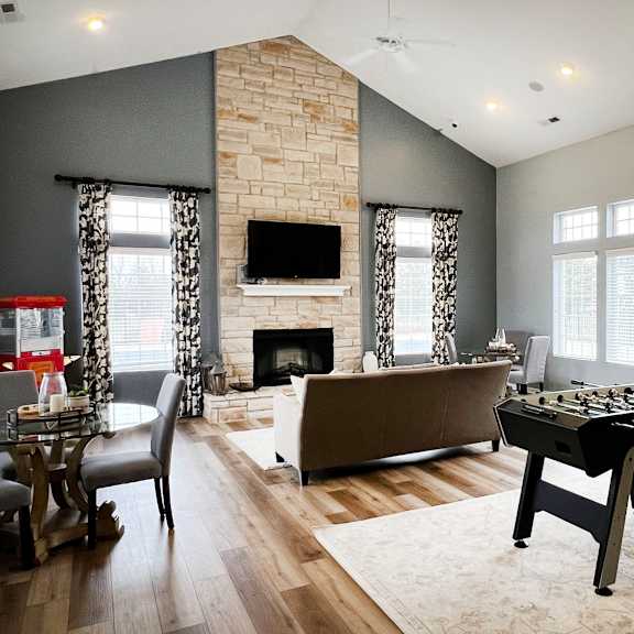 a game room with a foosball table and a couch