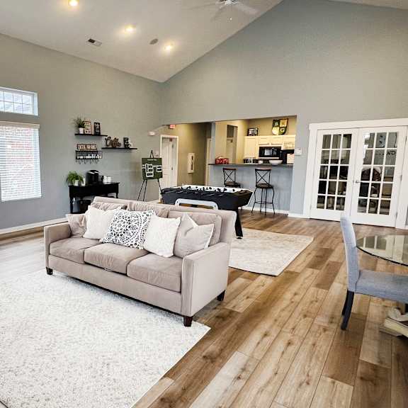 a living room with a couch and a table with chairs