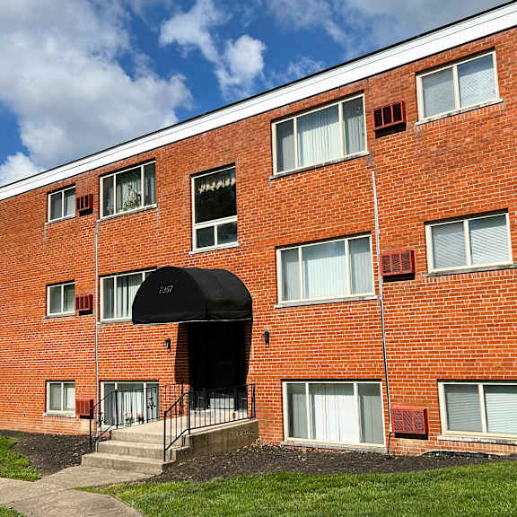 a brick building with an awning on the side of it at crown court apartments, kentucky, 41042