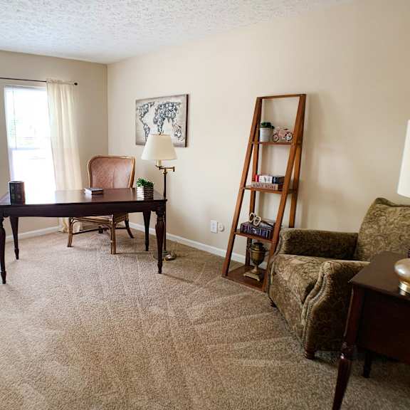 a living room with a desk and a couch  at knobs pointe apartments, new albany, in, 47150