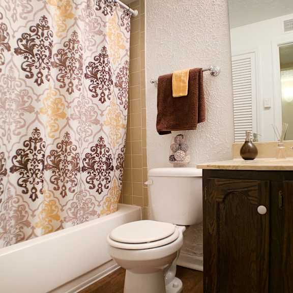 a bathroom with a shower and a toilet and a sink  at knobs pointe apartments, new albany, in