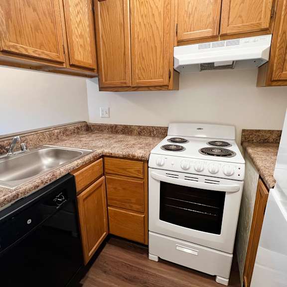 kitchen with white cabinetry and appliances  at concord woods apartments, ohio