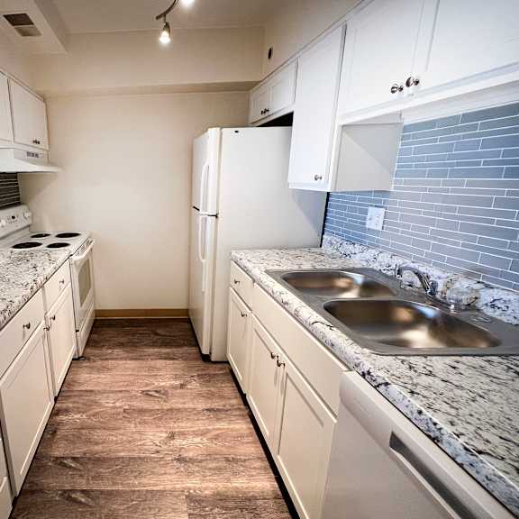 a kitchen with white cabinets at indian lookout apartments, cincinnati, oh