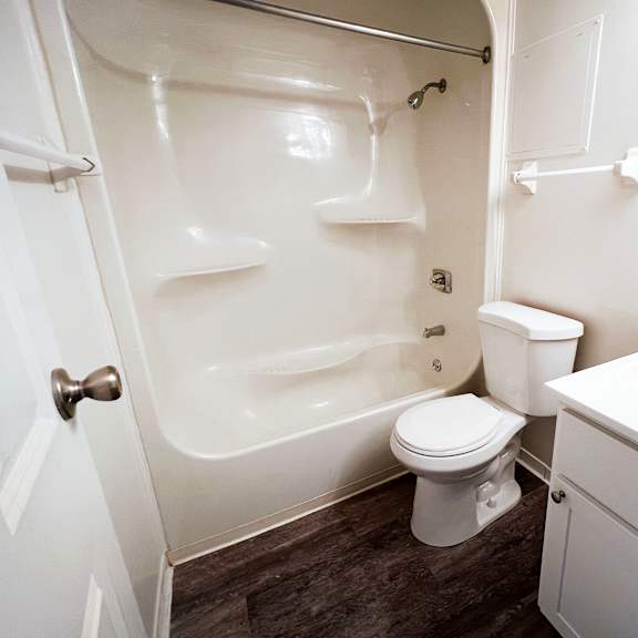 a bathroom with a white sink and toilet next to a white bathtub at indian lookout apartments, cincinnati