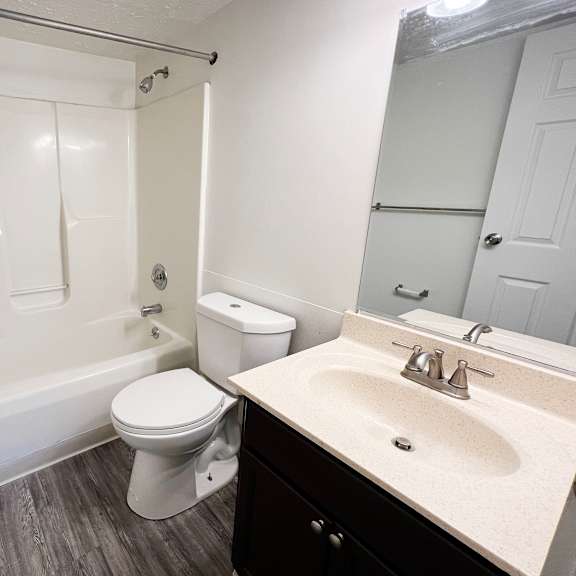 a bathroom with a bathtub toilet and sink at quail meadow apartments, cincinnati, oh