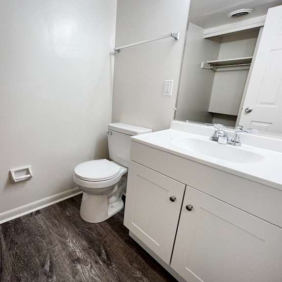 a bathroom with a toilet sink and mirror at wentworth estates apartments, florence, ky