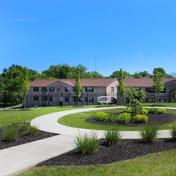 a park with a pathway and a building in the background  at four worlds apartments, ohio, 45231