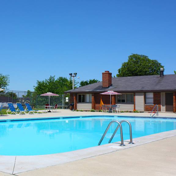 a swimming pool with a blue sky in the background.