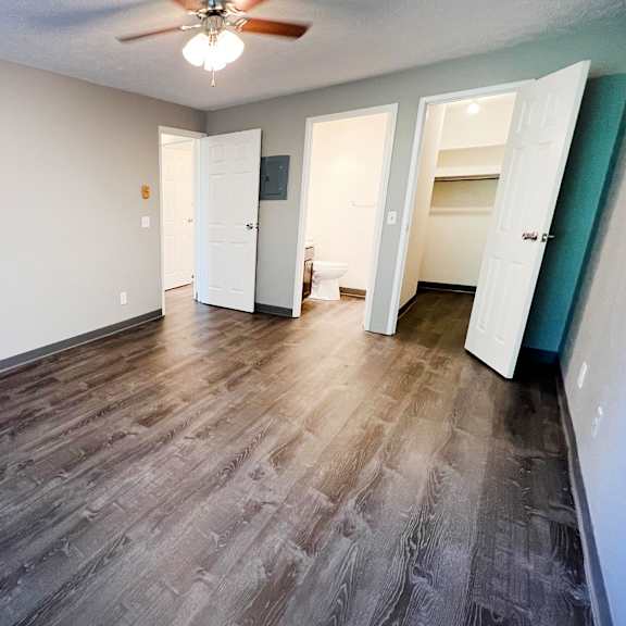 a bedroom with hardwood floors and a ceiling fan at quail meadow apartments, ohio