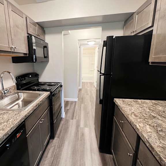a kitchen with gray cabinets and black appliances  at timber ridge apartments, cincinnati, oh, 45241