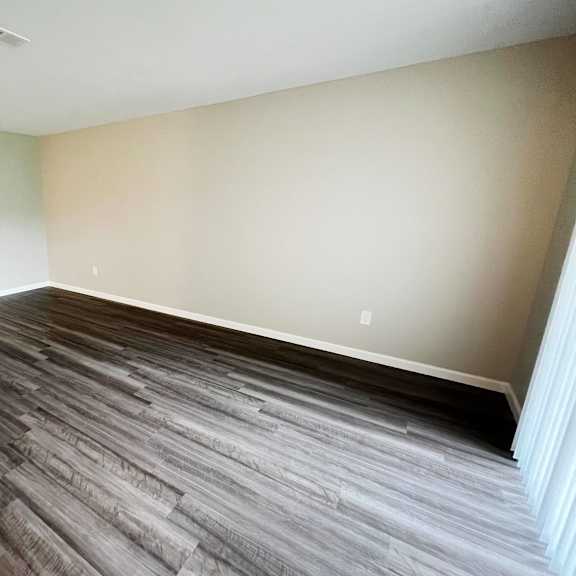 a bedroom with hardwood floors and white walls  at timber ridge apartments, cincinnati