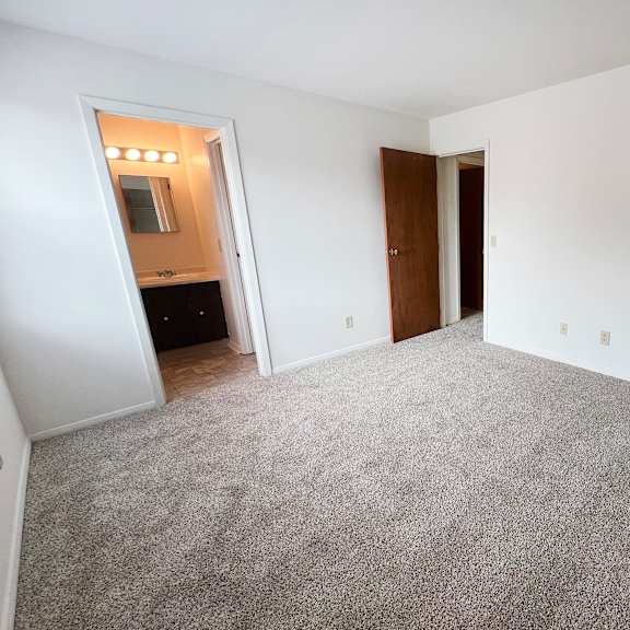an empty bedroom with a carpeted floor  at four worlds apartments, ohio, 45231