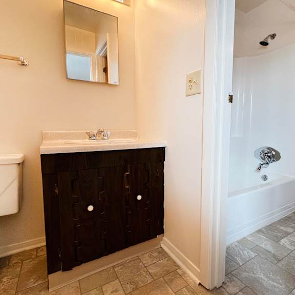 a bathroom with a toilet sink and bathtub  at four worlds apartments, cincinnati, oh