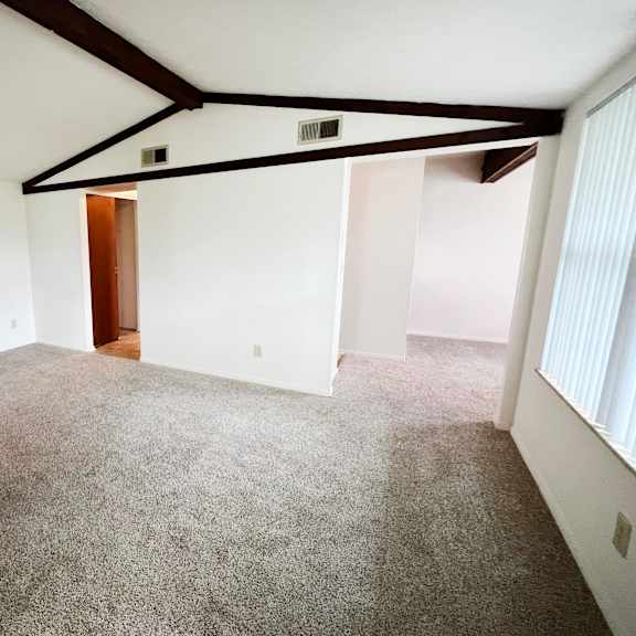 a bedroom with a carpeted floor and white walls  at four worlds apartments, cincinnati