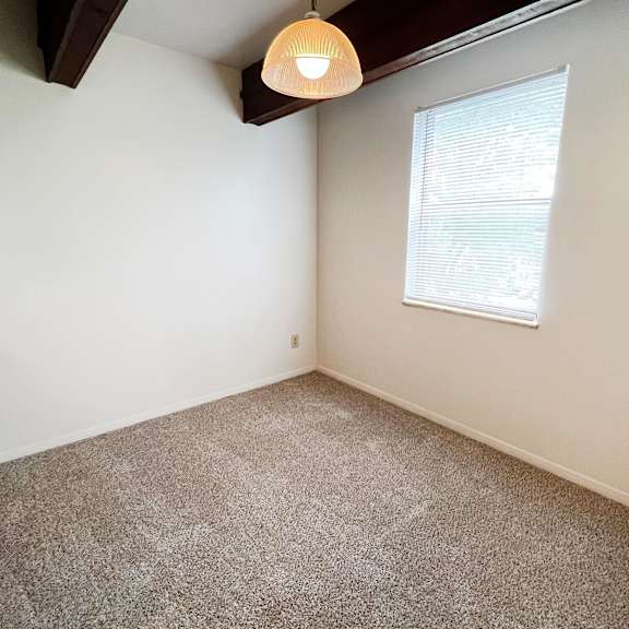 a bedroom with white walls and a window  at four worlds apartments, ohio, 45231