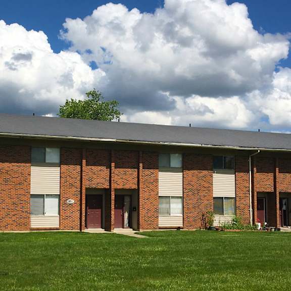 a building with a green lawn in front.