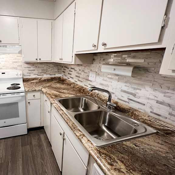 kitchen with appliances and white cabinets at oakwood apartments, florence