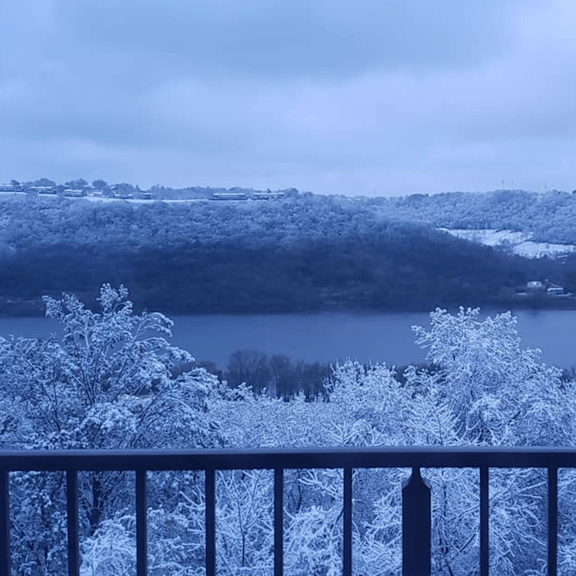 a balcony overlooking a lake and trees in the snow at indian lookout apartments, cincinnati, oh