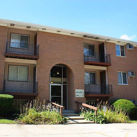 a red brick apartment building with an arched doorway at hunter ridge apartments, cincinnati