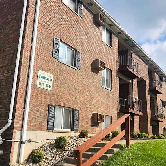 a brick building with a wooden fence in front of it at hunter ridge apartments, cincinnati, ohio