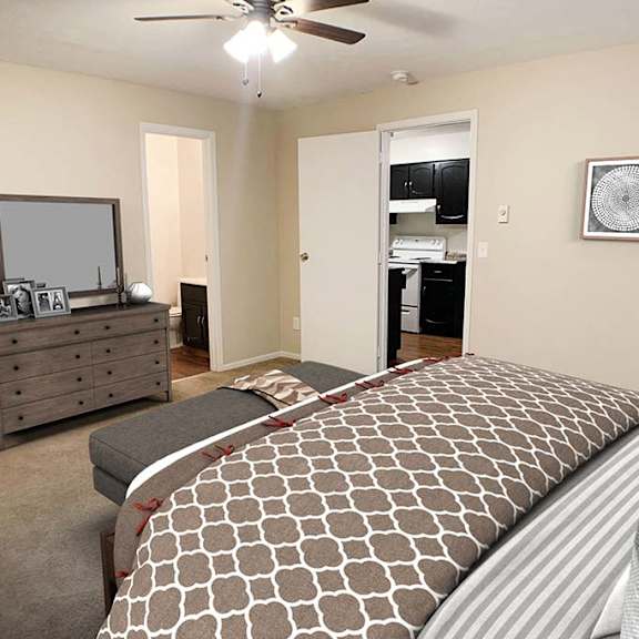 a bedroom with a bed and a dresser at hunter ridge apartments, cincinnati, oh