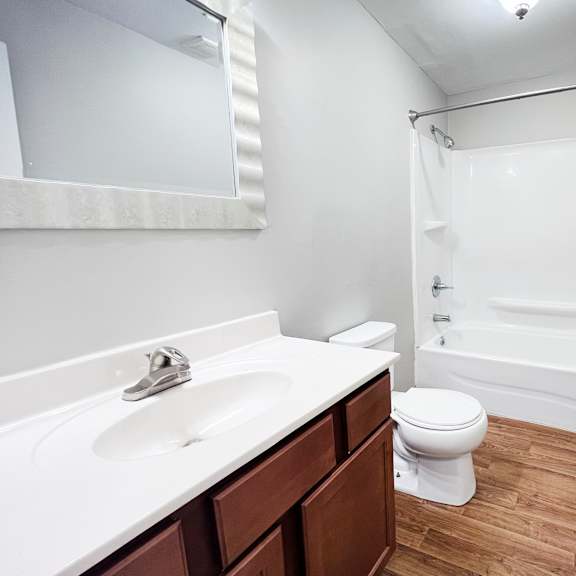 a white sink and toilet in a small bathroom.