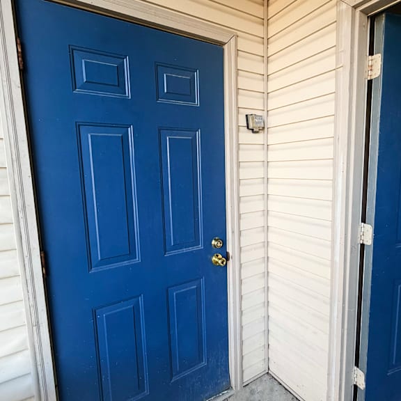 a blue door with a keyhole and a doorknob.