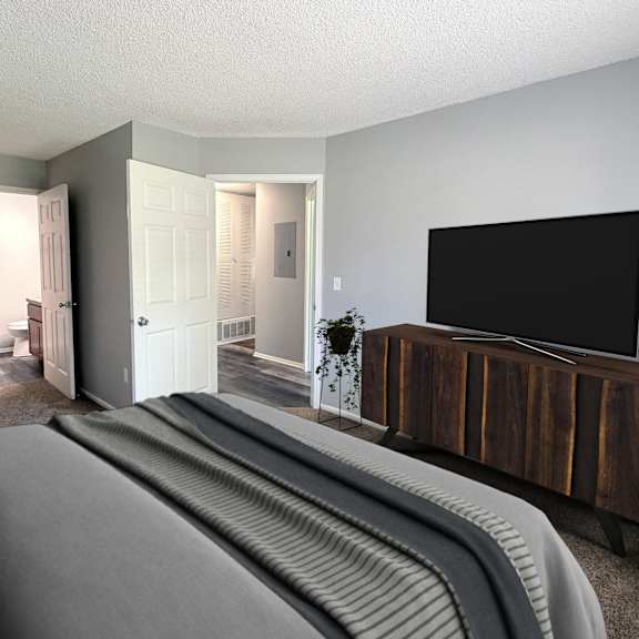a living room with a grey sofa and a wooden tv stand.