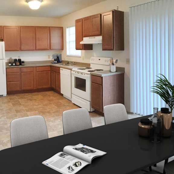 a kitchen with a black table and white chairs.