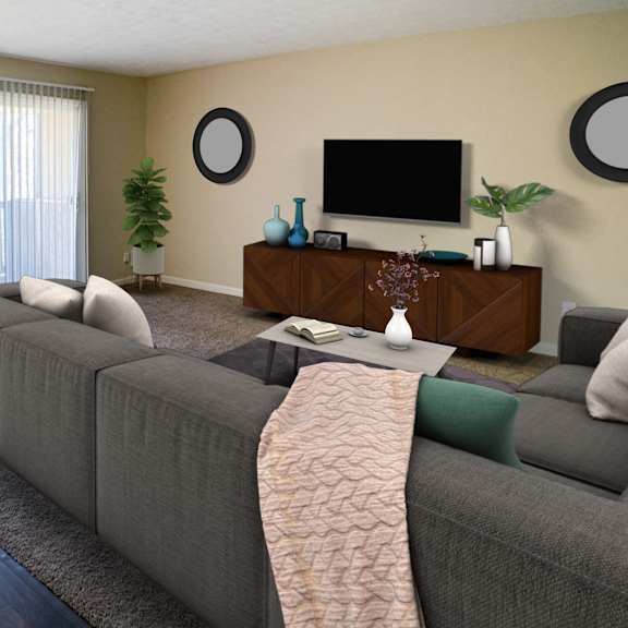 a living room with a gray couch and a television  at timber ridge apartments, cincinnati, oh, 45241